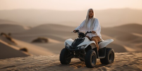 Caucasian female adult riding atv in desert landscape at sunset