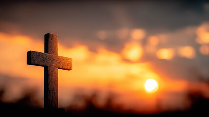 A wooden cross faces the setting sun, evoking faith rooted in sacrifice and the promise of redemption and hope.
