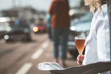 Woman enjoying a glass of rose wine outdoors on a sunny day
