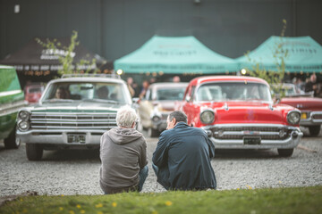 Classic car show with spectators enjoying vintage automobiles on display