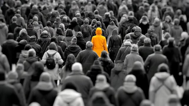 Bright yellow raincoat stands out in a crowded street during a rainy day in the city