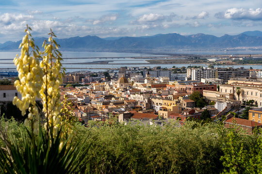 View of Sardinia's capital, Cagliari. Church of St. Michael (Cr&egrave;sia de Santu Miali), the Stampace and Marina districts, with boats/ships. In the background, mountains
