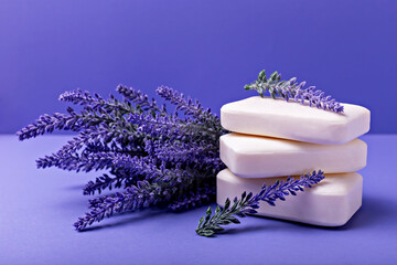 Lavender soap. Beauty and health. Stacked lavender soap bars are elegantly arranged with fresh lavender sprigs, creating soothing composition on vibrant purple background