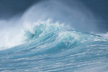 Aqua blue crashing surf on the Maui coast.