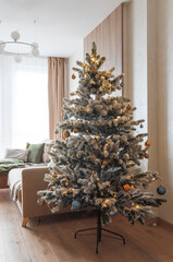 Festive Living Room with Snow-Flocked Christmas Tree and Cozy Decor