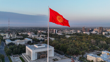 A large national flag waving proudly at Bishek Freedom Square