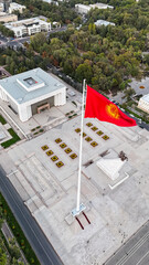 A large national flag waving proudly at Bishek Freedom Square