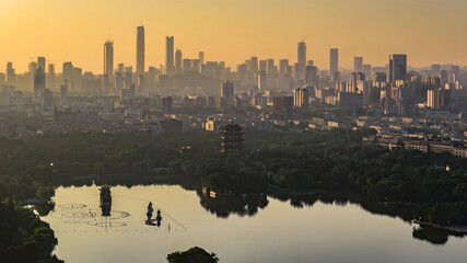 Jinan City Skyline at Golden Hour with Lake Reflection and Modern Skyscrapers