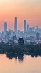 Jinan Skyline at Sunset with Traditional Pagoda and Lake Reflection, China