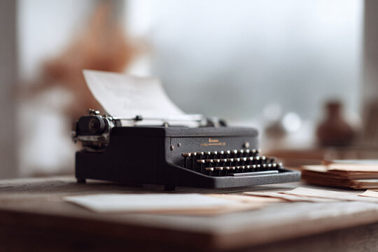 Vintage typewriter with paper on desk. Nostalgic, creative writing concept. Ideal for blog posts, articles, and website imagery, evoking inspiration and history.