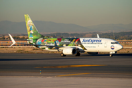 Avi&oacute;n de l&iacute;nea de Boeing 737 de la aerol&iacute;nea Sun Express en el aeropuerto de Madrid Barajas con decoraci&oacute;n especial de la pel&iacute;cula de los Pitufos y matr&iacute;cula TC-SPY.