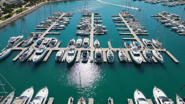 Enjoying a sunny day at the marina with many yachts and boats in the clear blue water