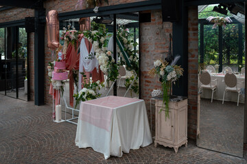 Elegant Birthday Celebration Setup with Pink Cake and Floral Decorations in a Chic Venue