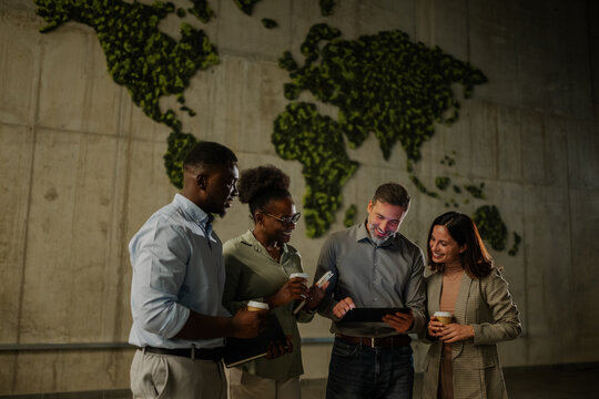 Diverse business people discussing global strategy using tablet