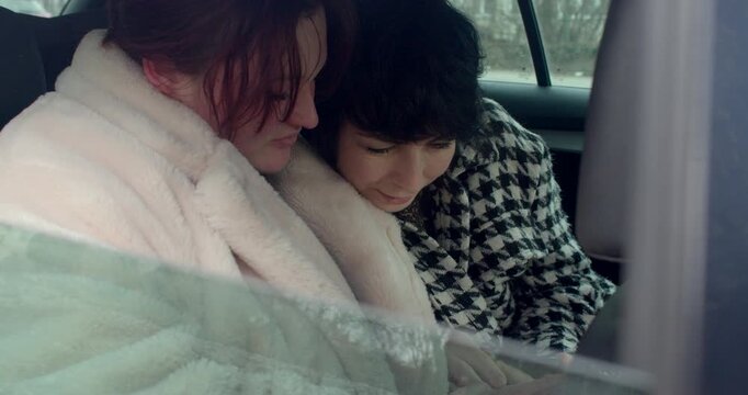 Women share heartfelt moments outdoors, Friendly women exchange affectionate support in public, Group of women share emotional support and comforting gestures while exploring Prague