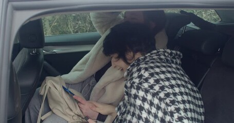 Women navigate Prague, Female drivers examine route collaboratively, Women in car coordinate using map application carefully, Two women in vehicle collaborate over navigation amid Prague cityscape