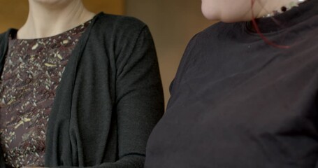 Supportive gesture during casual chat, Gentle smiles and reassuring touch at cozy cafe setting, Relaxed indoor scene with women exchanging friendly smiles and affectionate gestures over coffee