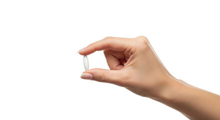 Woman's hand holding a small white oval pill between thumb and index finger isolated on a transparent background