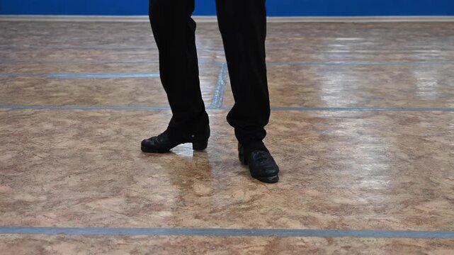 Close-up of male legs dancing traditional Irish stepdance. 