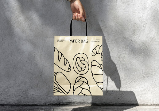 Hand holding a Custom-Designed Paper Bag Mockup