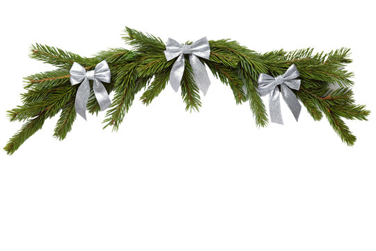 Festive christmas fir garland decorated with elegant silver bows, perfect for holiday background, banner decoration or festive frame element