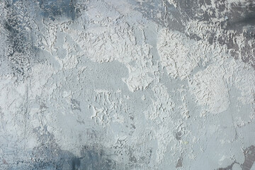 Textured gray wall with fine details and subtle variations visible in natural light