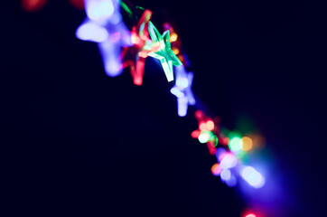 Twinkling Star-Shaped Christmas Lights Blur at Night Copyspace