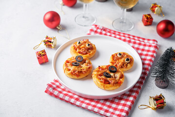 Pizza mini with salami in the form of snowman for Christmas holidays on a white background