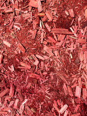 Close-up of Red wood Chips backdrop. Natural Mulch background for garden design and eco-projects. Bark texture macro. Wooden Surface for packaging. Landscape design for site decoration. Vertical photo