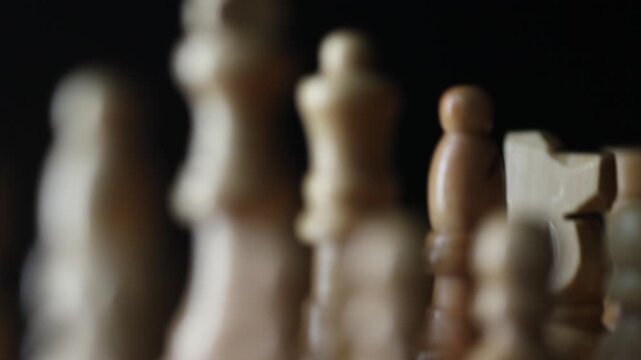 Animated sequence showing chess pieces on revolving board, capturing the essence of strategic decision-making and the black versus white dichotomy in chess