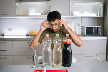 Chemist wearing safety glasses carefully preparing fertilizer for plants in kitchen, using various liquids and bottles, ensuring mixture safe and effective for promoting plant growth.