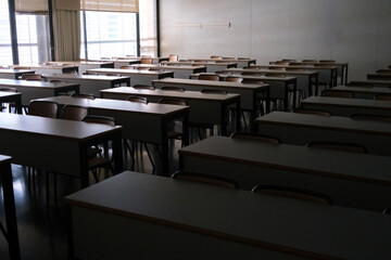 Classroom features rows of empty desks and chairs, creating a serene atmosphere ideal for study
