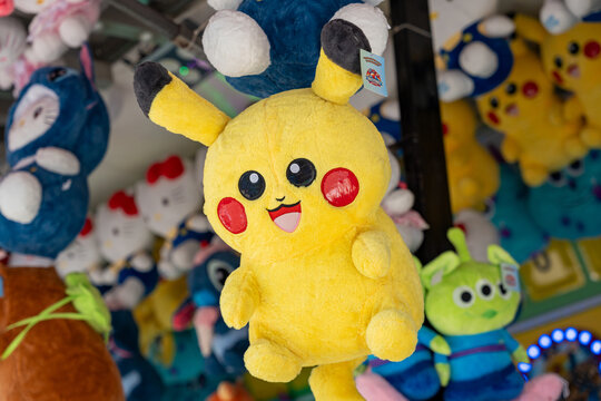 Counterfeit plush toy of the popular anime character Pikachu, displayed at a fair stand or flea market. Pokemon, Jalisco, Mexico, Nov. 10, 2025.