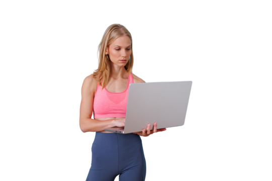 Woman working on laptop, preparing for a home fitness workout, staying active with online digital technology