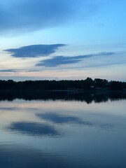 Serene twilight reflection over calm waters of a lake near Sosnowiec, Katowice, Silesia, Poland, May 2024