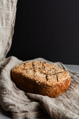 Homemade artisan bread loaf with sesame seeds on linen