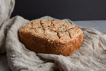 Homemade whole grain bread loaf with sesame seeds