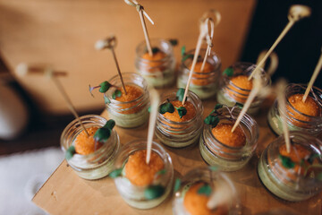 Gourmet appetizers in small jars for catering event