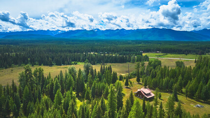 Aerial Wyoming Rustic House Pine Forest and Mountain Range Scenic View