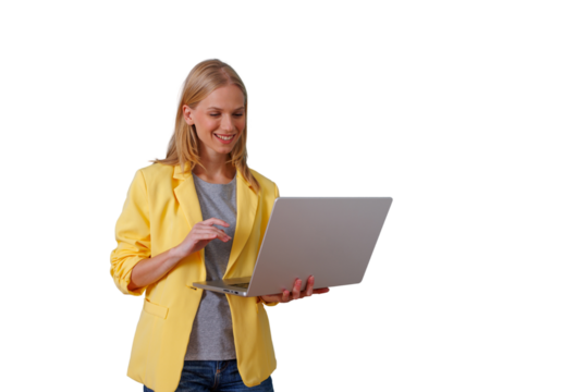 Young businesswoman using laptop, smiling and working remotely, standing, wearing yellow blazer, transparent background