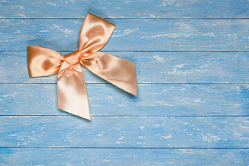 beautiful gift bow on a wooden background