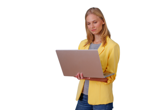 Professional woman in yellow jacket standing and working on a laptop, connected to business and technology