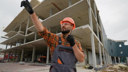 Construction foreman managing project using walkie talkie