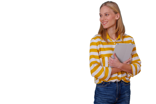 Young woman student holding tablet computer, smiling and looking away, enjoying mobile technology