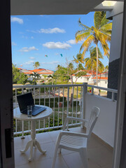 Fototapeta premium Remote work from hotel balcony with laptop and tropical view in Cuba