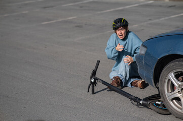 Obraz premium A Caucasian woman on a scooter after being hit by a car.