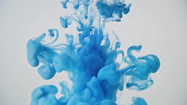 Blue ink dissolving in water creating a beautiful abstract pattern