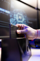 Close up of hacker using SSD to store data gathered from victims using spyware installed on their...