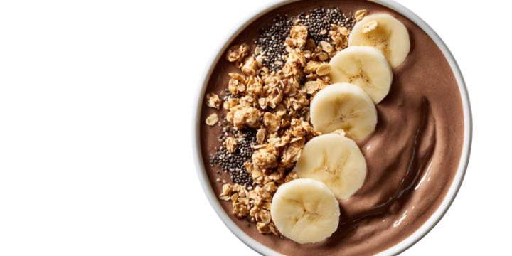 Delicious chocolate smoothie bowl with banana slices, granola, and chia seeds Healthy breakfast concept with fresh ingredients for a nutritious start