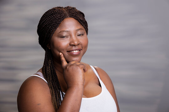 African American skincare model showcasing radiant skin and minimal makeup, positive feminine energy for beauty advertisement. Empowering vibrant take on wellness and cosmetics.